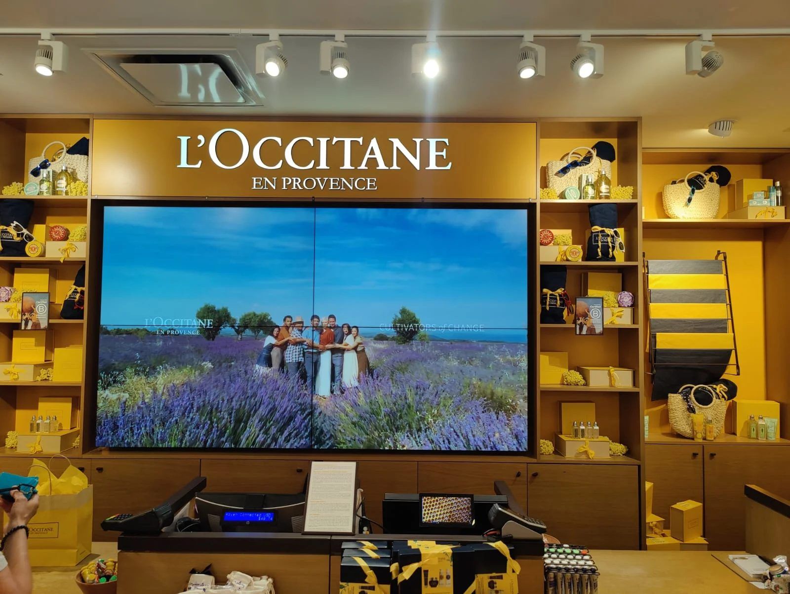CrownTV install: large commercial display on the feature wall of a L'Occitane store