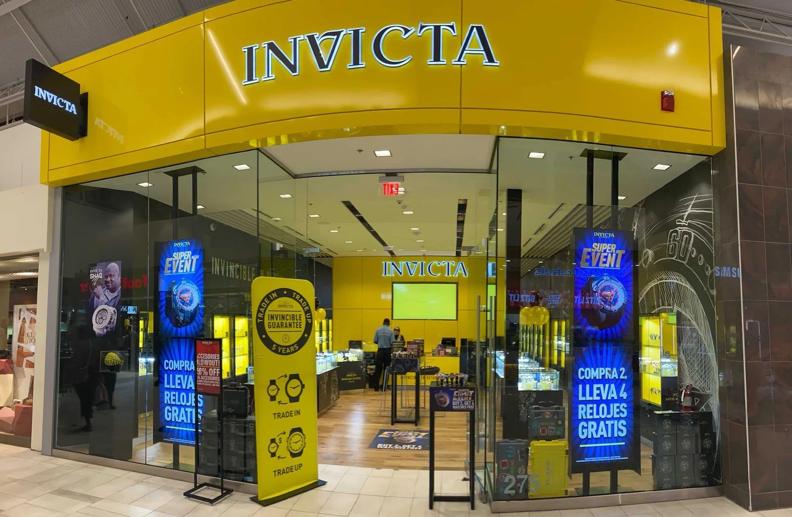 CrownTV install: portrait displays on floor stands across a retail storefront