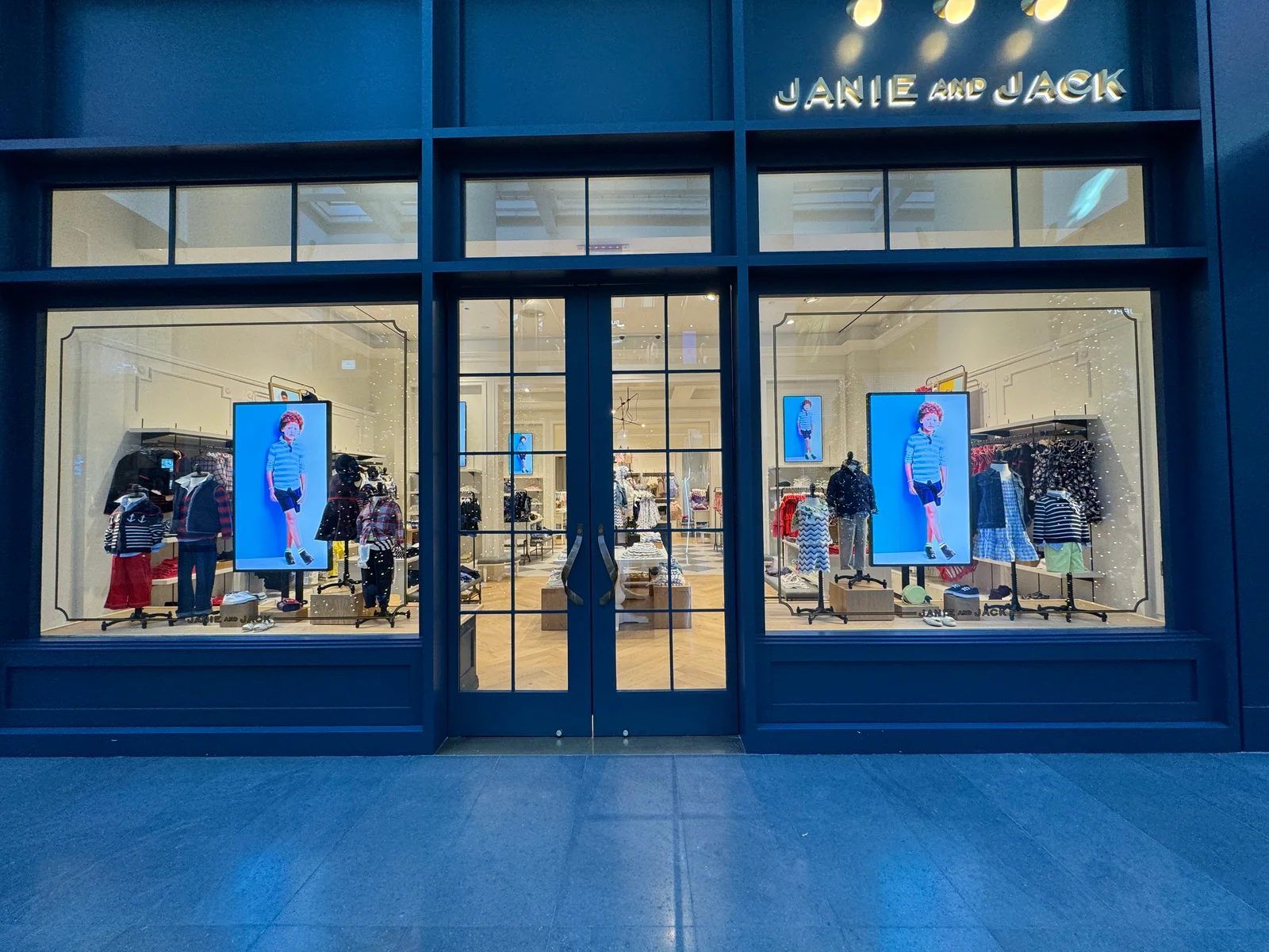 TV rental NYC: Janie and Jack storefront in Manhattan with CrownTV window screens